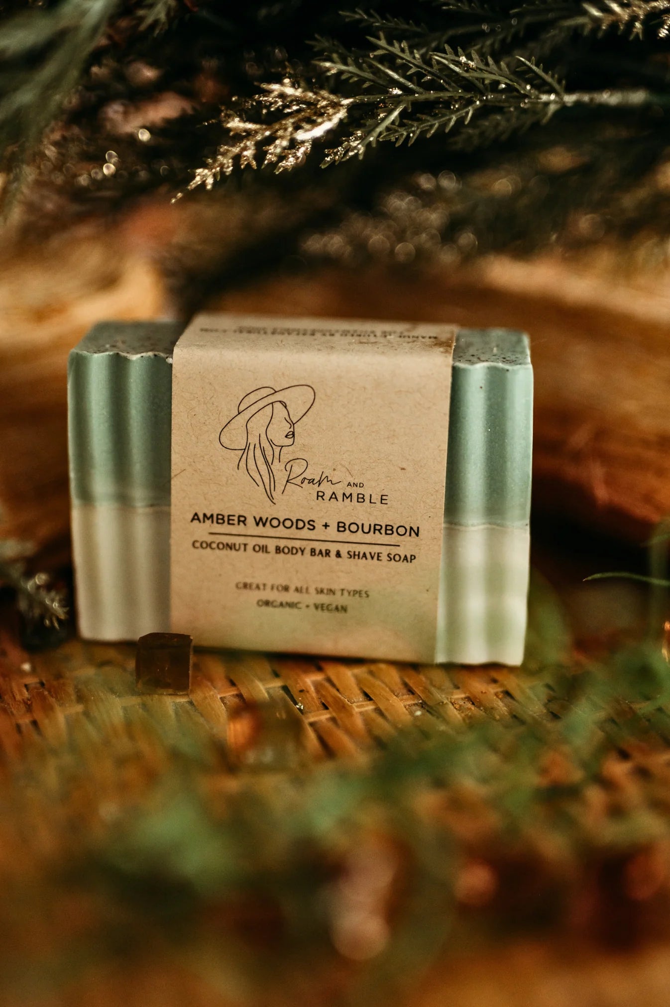 Bar of soap with a label on a woven surface with greenery