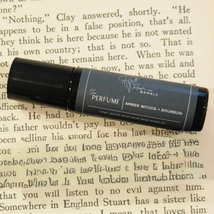 Roll-up perfume bottle labeled 'The Perfume' on a piece of text