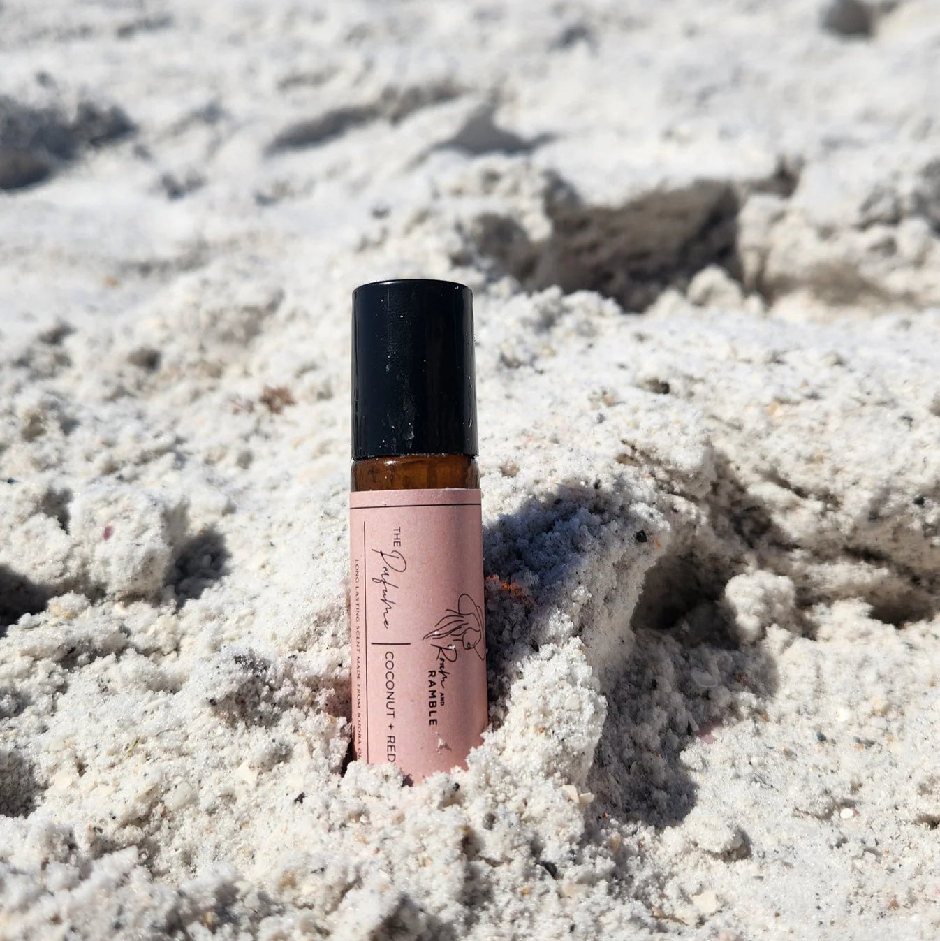 Perfume Roller on a sandy beach with ocean in the background