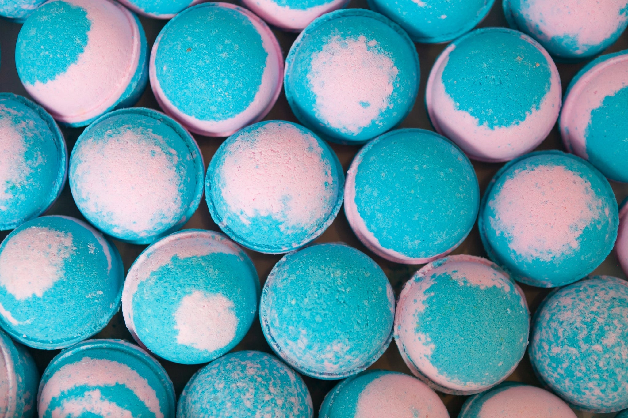 Close-up of blue and pink bath bombs with a textured surface.