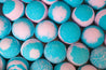 Close-up of blue and pink bath bombs with a textured surface.