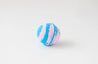 Blue and pink striped bath bomb on a white background