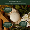 Soap bar with botanical elements and text about fresh citrus scent and ingredients.