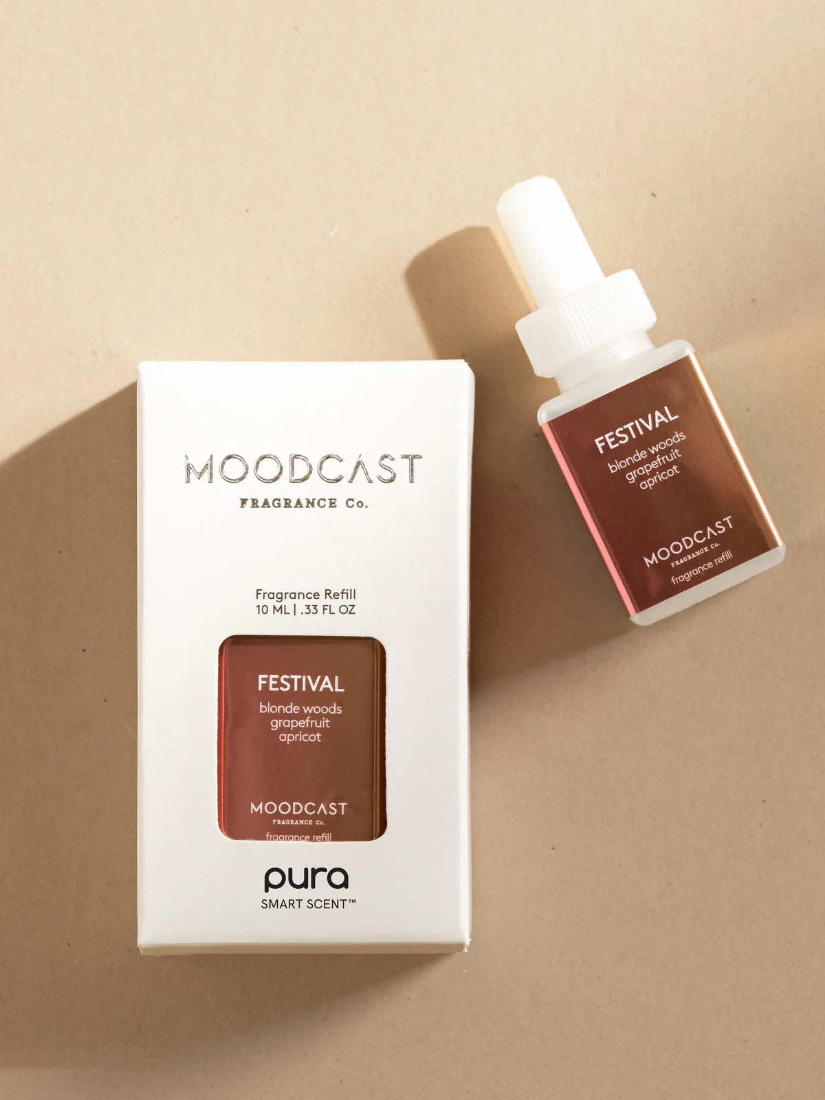 Moodcast fragrance refill bottle and packaging on a beige background
