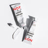 Juliette Has a Gun Not A Hand Cream 30mL, available at Rafa Natural. Products laying down with a lotion smear.