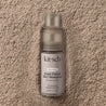 Kitsch dark tinted dry shampoo bottle on a textured beige surface