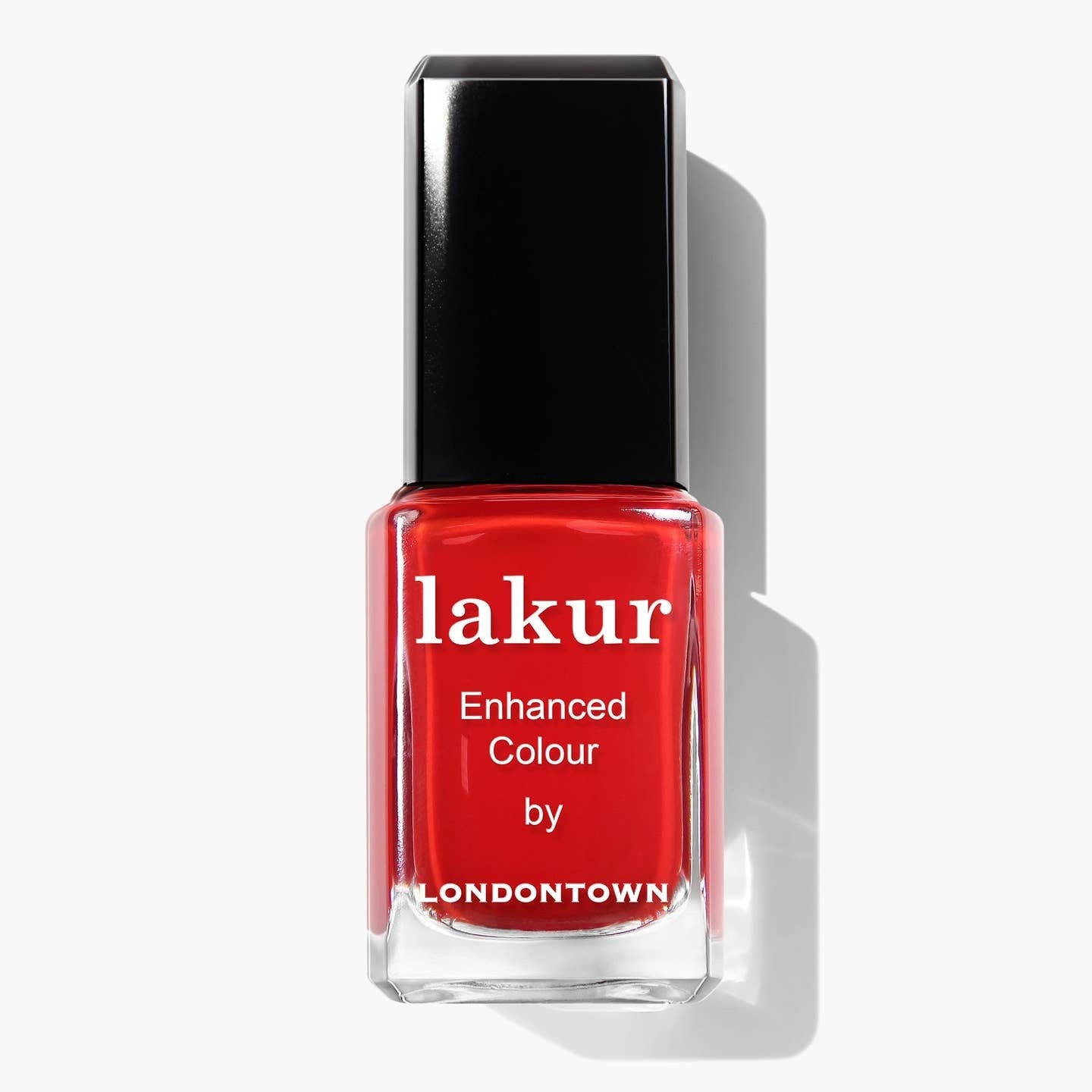 Red nail polish bottle with black cap on a white background