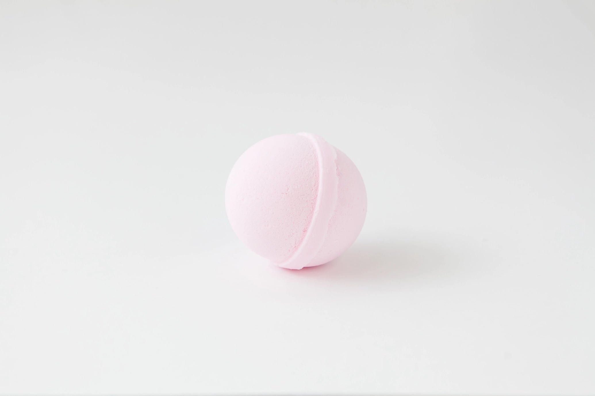 Pink bath bomb on a white background