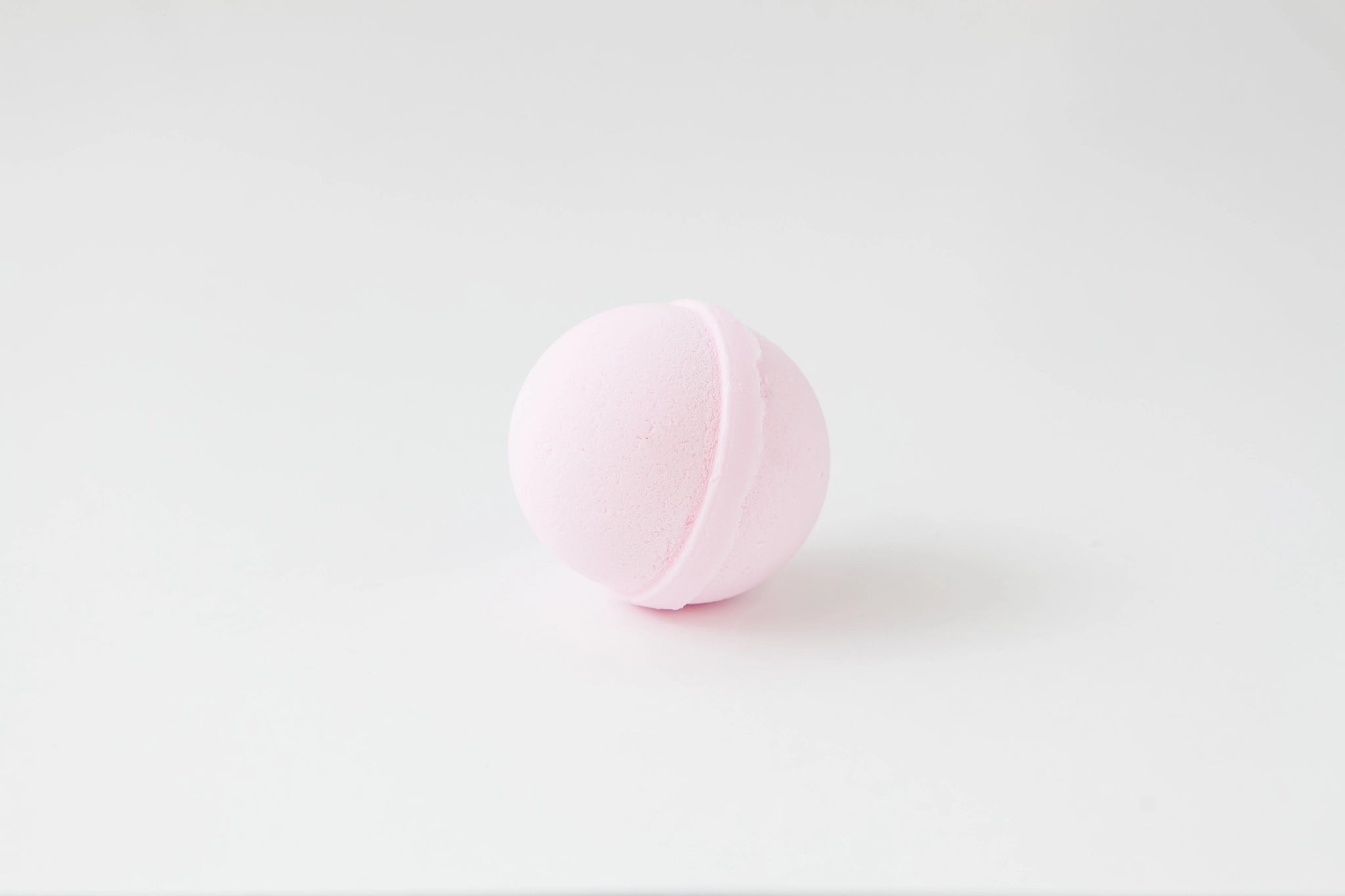 Pink bath bomb on a white background