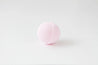 Pink bath bomb on a white background