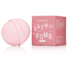 Pink bath bomb with packaging on a white background