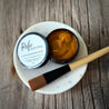 Pumpkin enzyme mask with a brush on a wooden surface