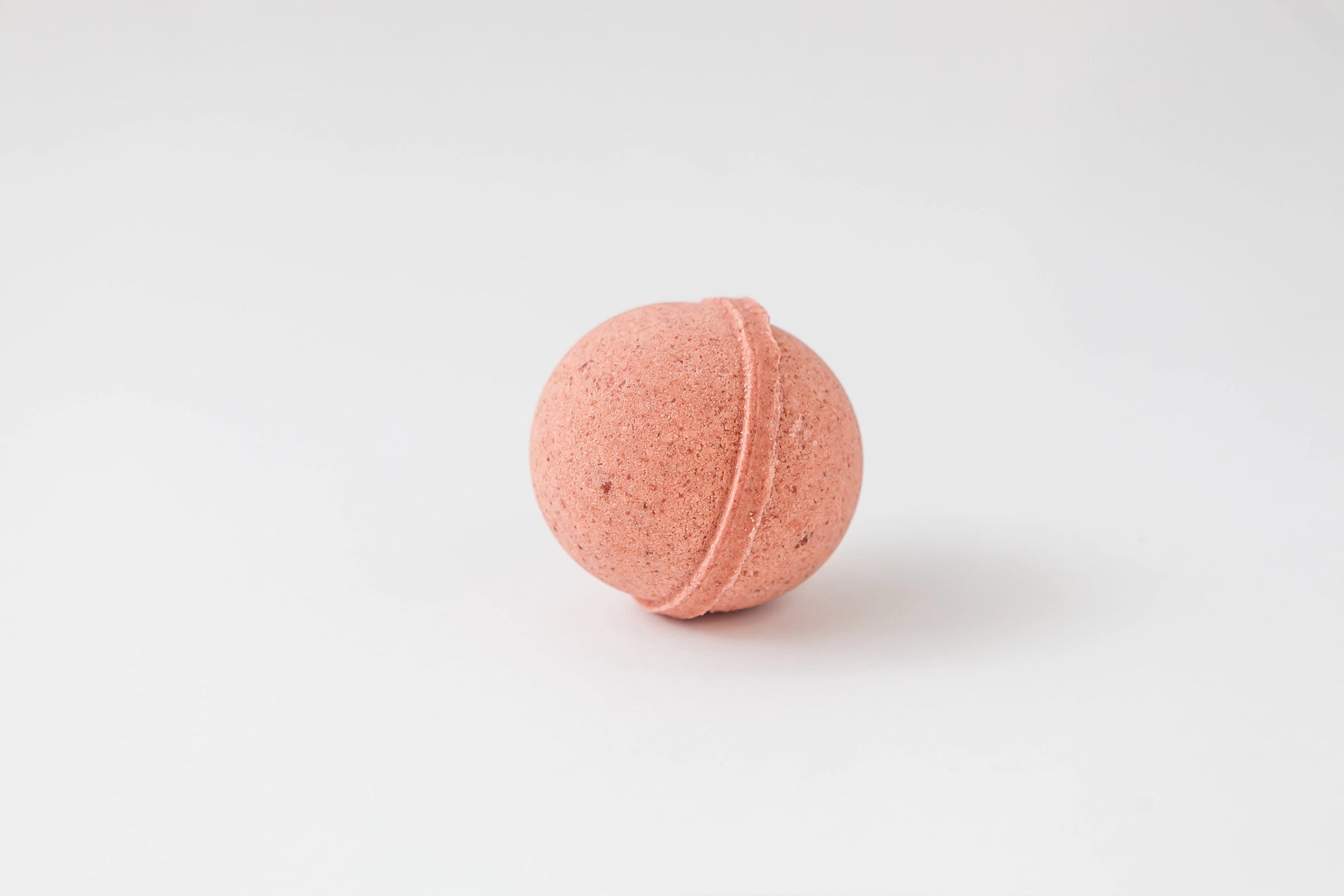 Pink bath bomb on a white background