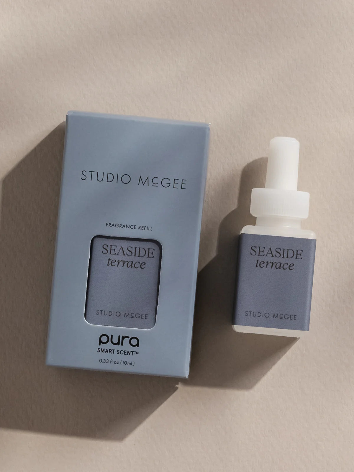 Studio McGee Seaside Terrace fragrance refill packaging and bottle on a beige background