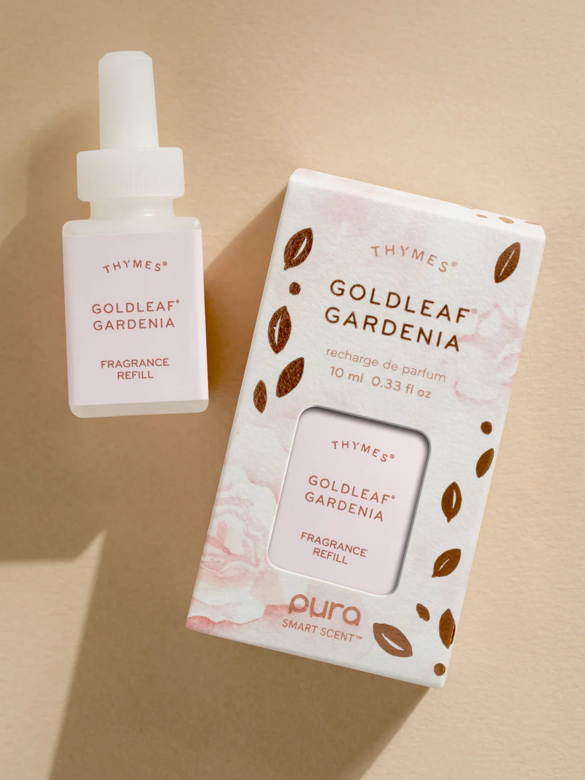 Thymes Goldleaf Gardenia fragrance refill bottle and packaging on a beige background