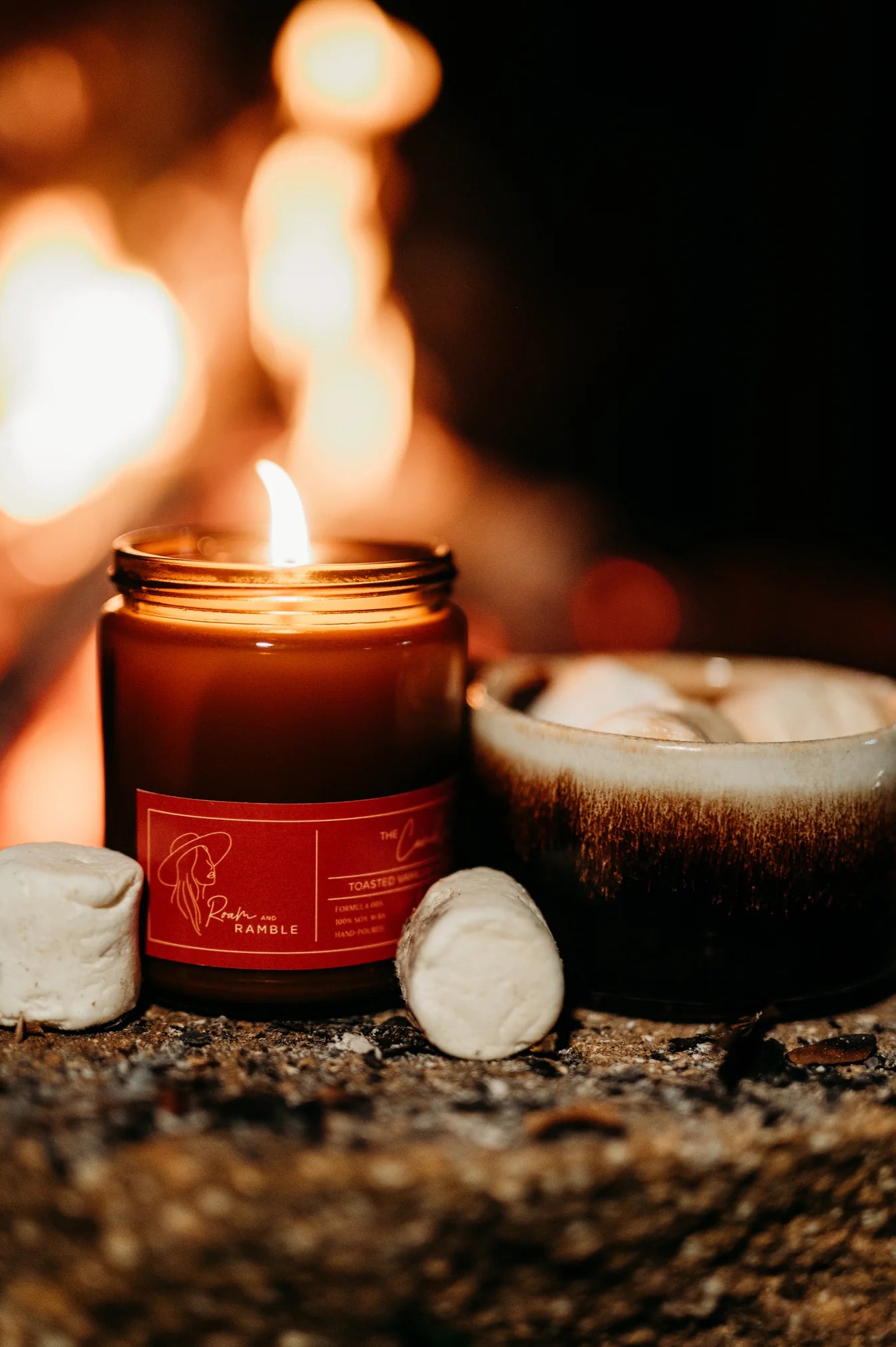 Candle with a red label on a stone surface with a blurred background