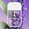 Touchland Pure Lavender Power Mist, in front of a close up of a lavender flower stalk.