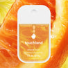 Touchland Citrus Grove Power Mist, in front of close up on orange slice.