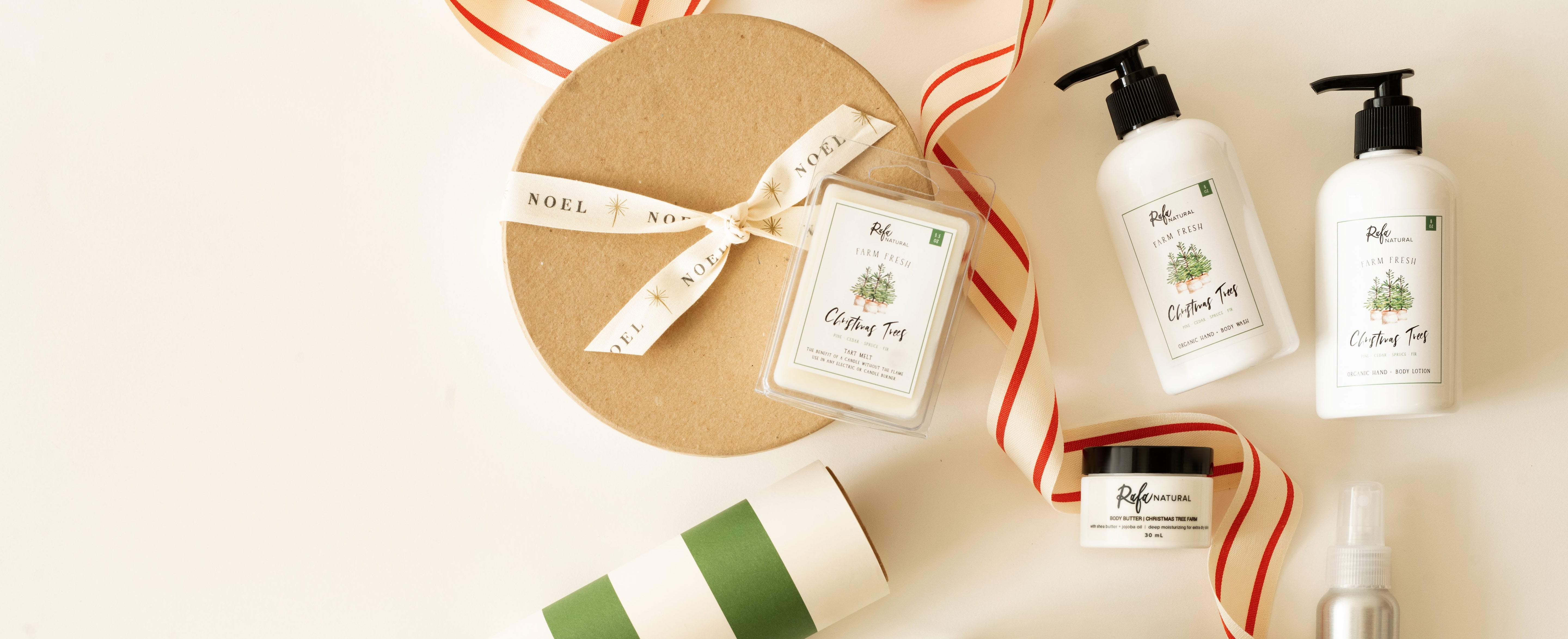 Assorted Tree Farm products including bottles, jars, and a candle on a light background with decorative ribbons.